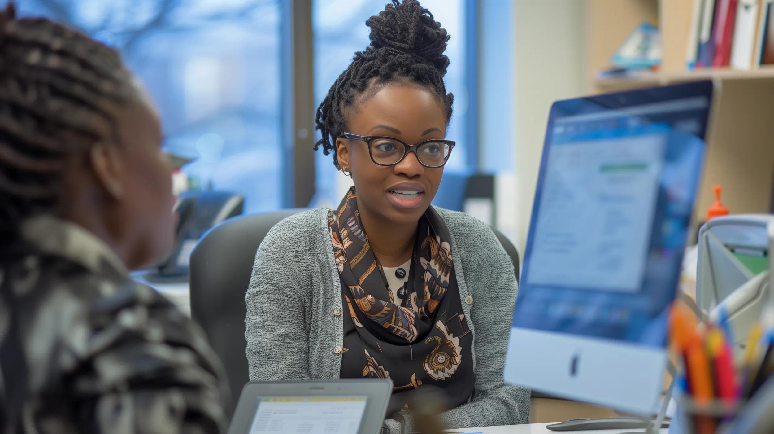 A mentor talking to a younger healthcare professional in a leadership review role