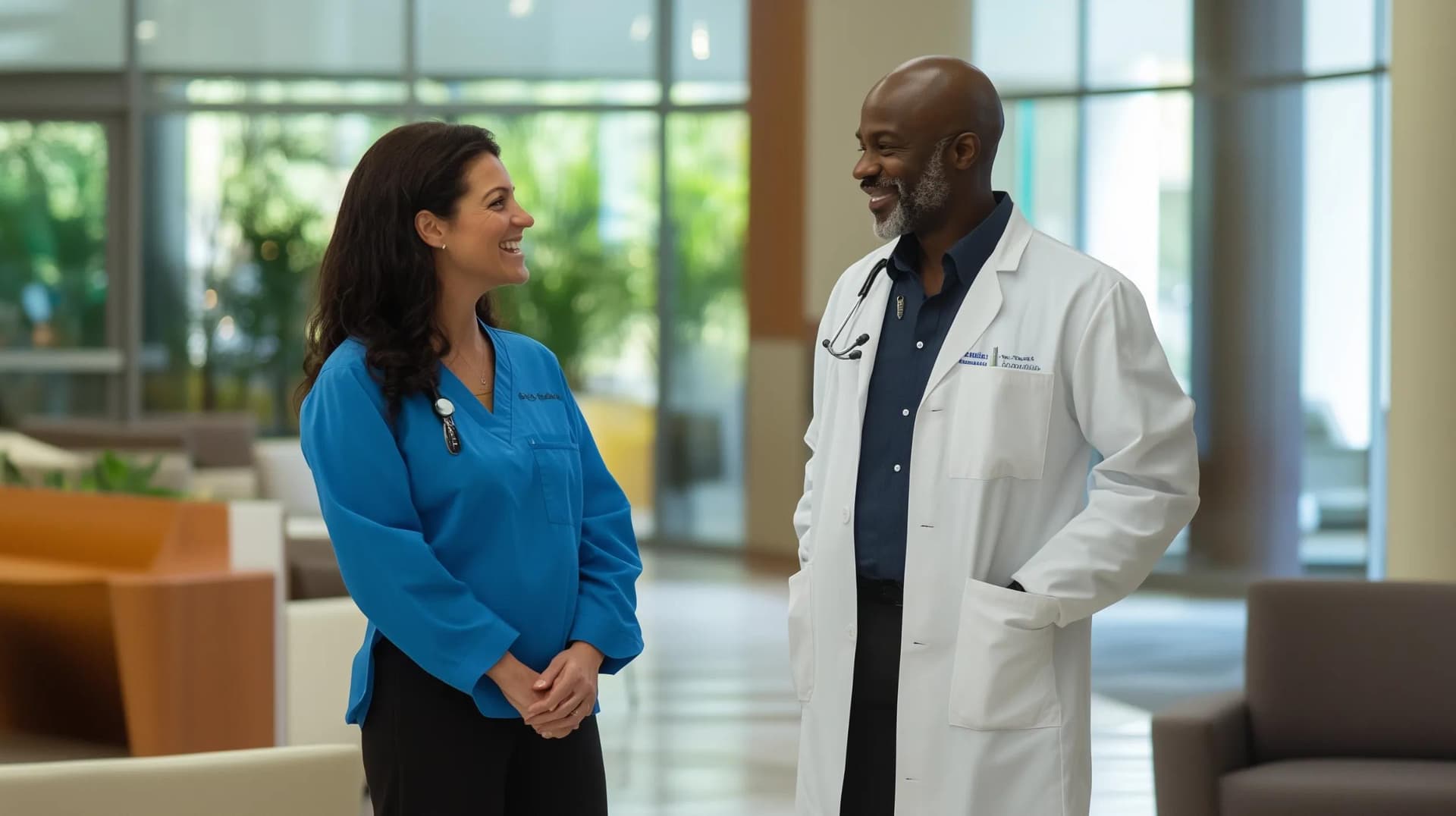 Two healthcare management professionals talking at a healthcare facility lobby